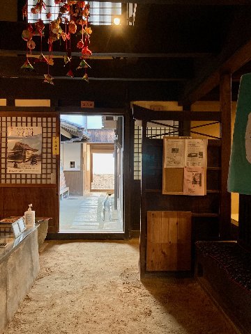 土間の床が土のままで庭に通り抜けできるようになっている海駅館土間の写真