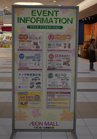 通路に設置された「イベント インフォメーション」と書かれた案内看板の写真
