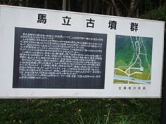 白い看板に黒文字で「馬立古墳」とタイトルが書かれ灰色の下地に白文字で説明が書かれてその右側に周辺の地図が描かれている案内板の写真
