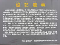 灰色の看板のようなものに黄色で書かれた「越部廃寺」と言うタイトルとその下に白色の文字で書かれている説明文の写真