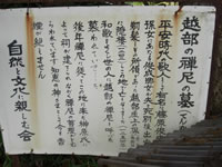 白色の金属の看板に黒色の文字で「越部の禅尼の墓」と書かれている写真